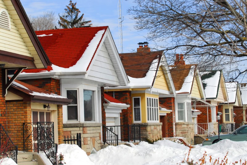 Street view of houses with snow.